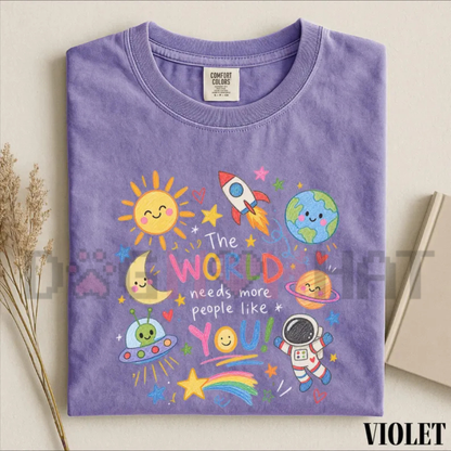 Front view of The World Needs More People Like You Kindness Space T-Shirt displaying cosmic galaxy graphics printed across the chest. - dogmomhat