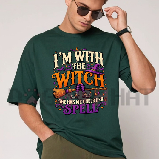 Front view of the I'm With The Witch T-Shirt displaying vintage witch broom artwork and typography printed across the chest of a black crew neck tee. - dogmomhat