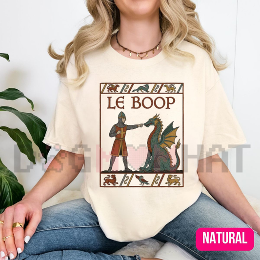 Front view of the Le Boop Medieval Fantasy T-Shirt displaying knight and dragon nose boop artwork printed across the chest of a garment-dyed cotton tee. - dogmomhat