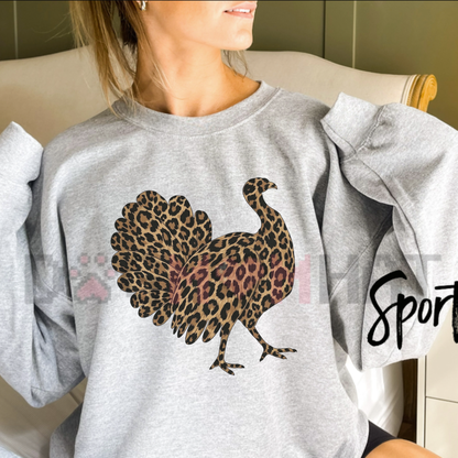 Front view of the Leopard Print Turkey Thanksgiving Sweatshirt displaying animal print turkey artwork printed across the chest of a cozy fleece crewneck. - dogmomhat