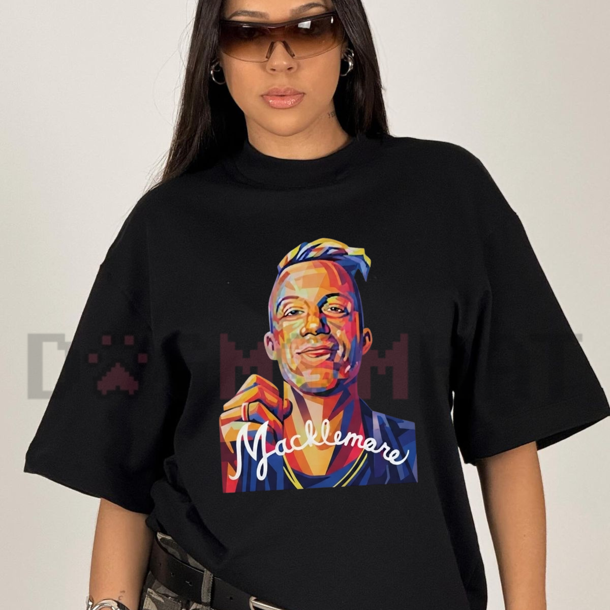 Front view of the Macklemore World Tour 2026 T-Shirt displaying hip-hop concert graphic artwork printed across the chest. - dogmomhat