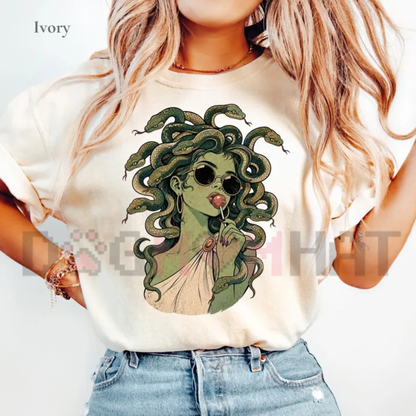 Front view of the Medusa Lollipop T-Shirt displaying spooky cute retro cartoon Medusa licking a swirl lollipop printed across the chest. - dogmomhat