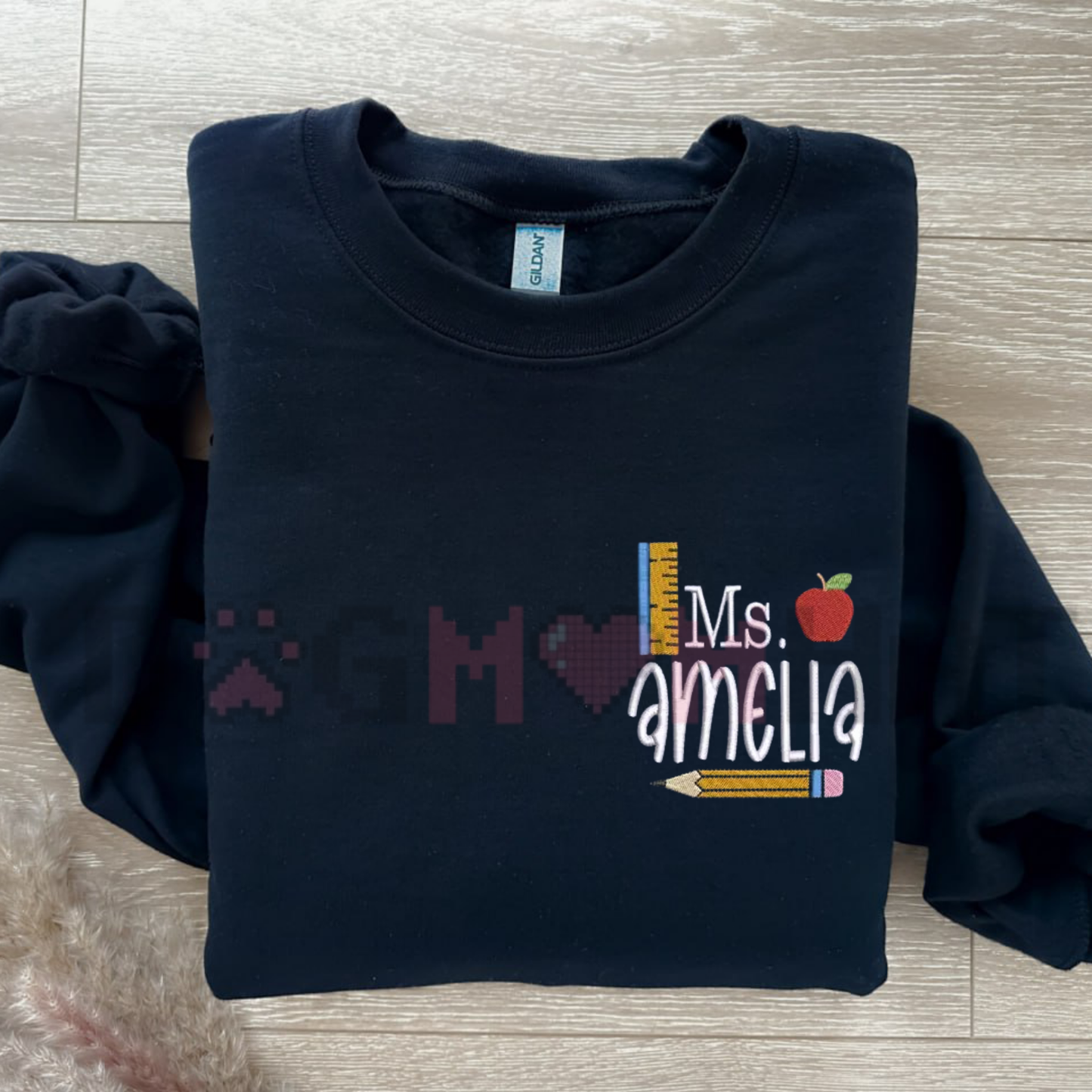 Front view of the Personalized Teacher Sweatshirt showing the custom embroidered name and school icon details across the chest. - dogmomhat
