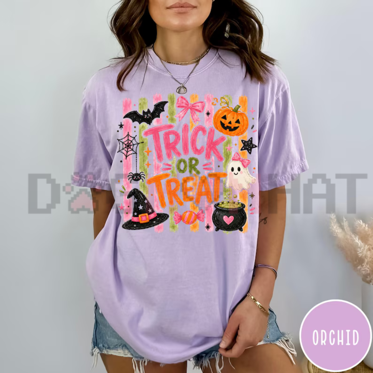 Front view of the Trick Or Treat Coquette T-Shirt displaying cute pink lettering and ribbon bow graphics printed across the chest. - dogmomhat