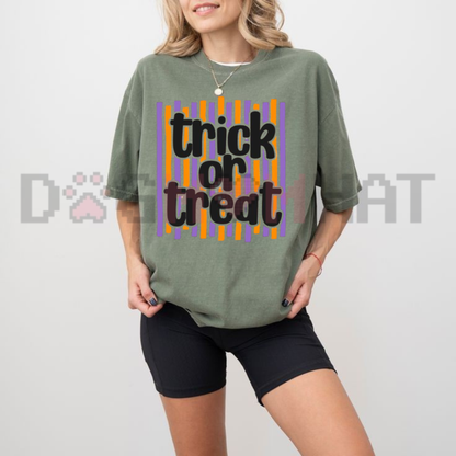 Front view of the Trick or Treat Preppy Striped Words T-Shirt displaying pink and orange preppy striped typography printed across the chest. - dogmomhat