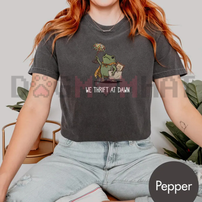 Front view of the We Thrift At Dawn Funny Frog Meme T-Shirt displaying thrifting frog artwork printed across the chest. - dogmomhat