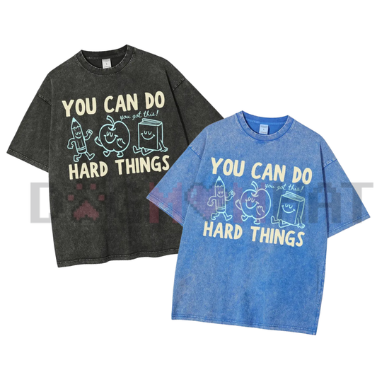 Front view of the 'You Can Do Hard Things' Vintage Washed T-Shirt displaying the retro doodle graphic printed across the chest of a mineral-washed tee. - dogmomhat