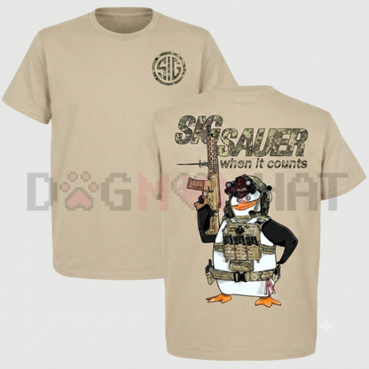 Front view of the black Tactical Penguin Graphic T-Shirt showing the detailed combat penguin artwork and 'When It Counts' slogan printed across the chest - dogmomhat