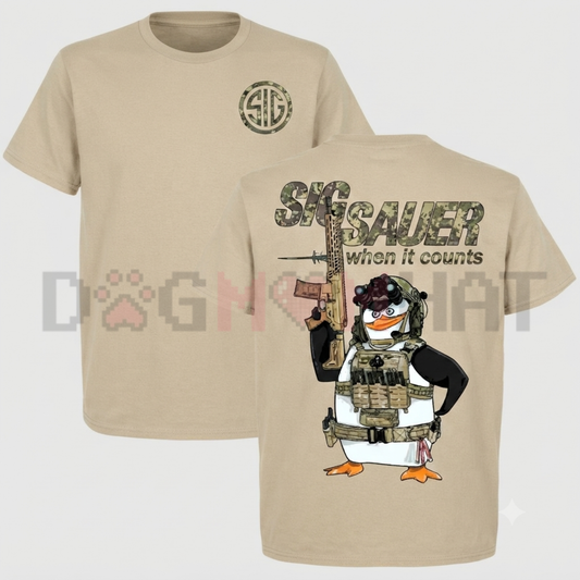 Front view of the black Tactical Penguin Graphic T-Shirt showing the detailed combat penguin artwork and 'When It Counts' slogan printed across the chest - dogmomhat