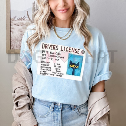 Front view of the blue Petee The Cat Funny Driver Graphic T-Shirt showing the detailed driving cat illustration printed across the chest - dogmomhat
