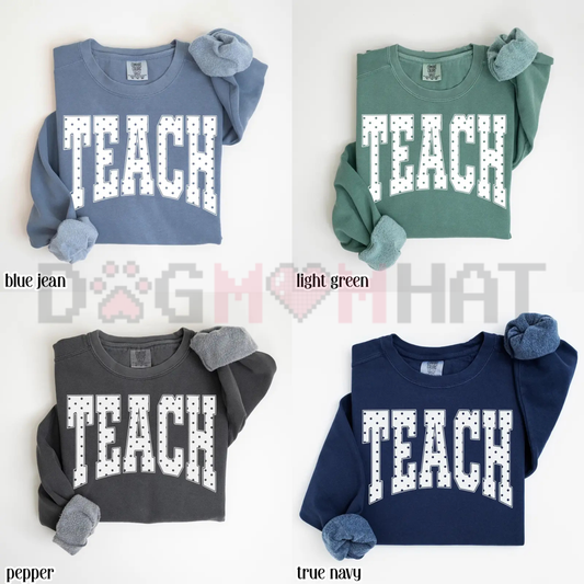 Front view of the cozy Comfort Colors Teach Sweatshirt showing the blue polka dot typography and floral graphic print across the chest - dogmomhat
