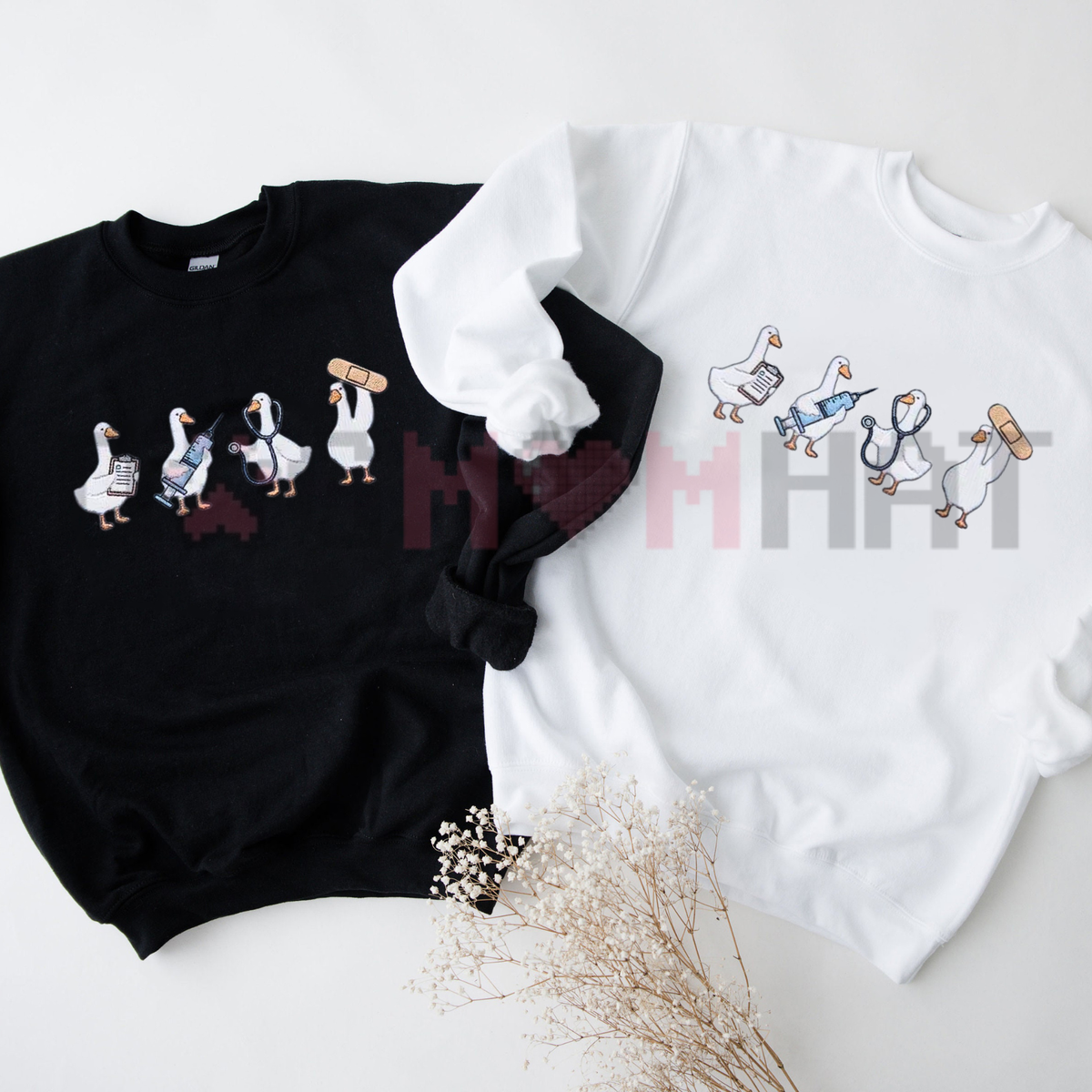 Front view of the healthcare quacker faux embroidery pullover displaying cute nurse duck graphic artwork across the chest of a cozy fleece crewneck sweater. - dogmomhat