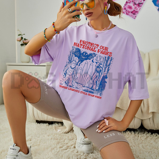 Front view of the moss green Comfort Colors Cryptid National Parks T-Shirt showing the detailed retro park badge graphic print across the chest - dogmomhat