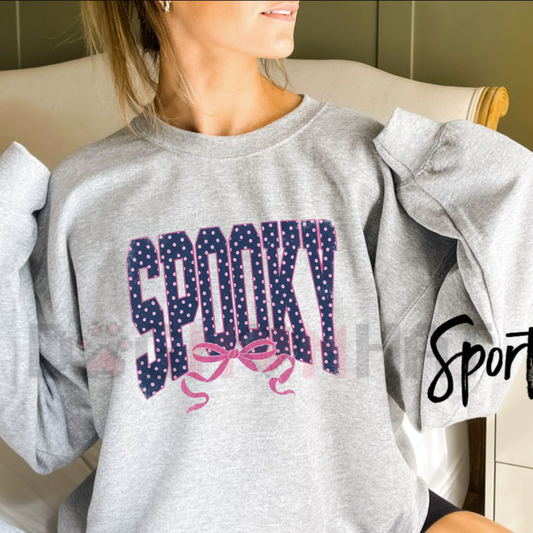 Front view of the soft light pink Girly Spooky Sweatshirt showing the detailed pastel ghost with bows graphic design across the chest - dogmomhat