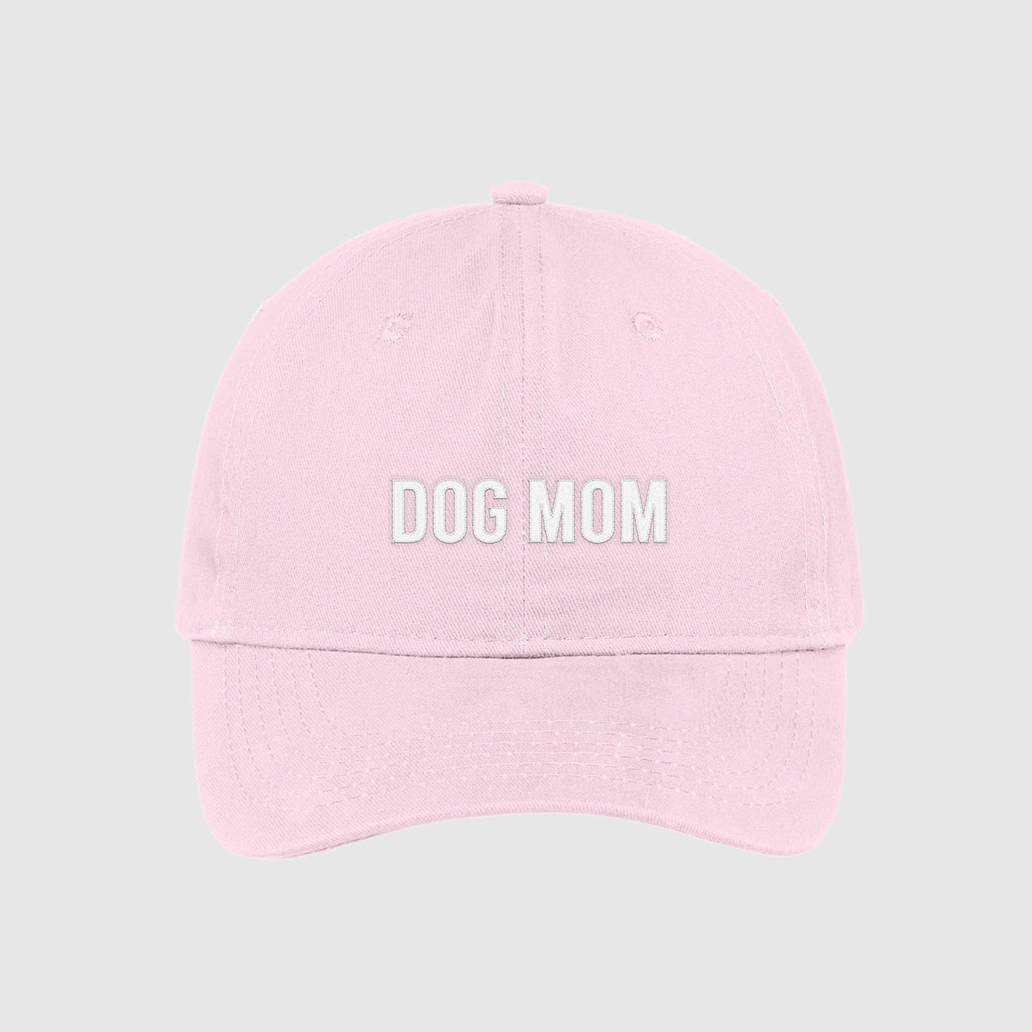 Blush pink Dog Mom Hat embroidered with white text.