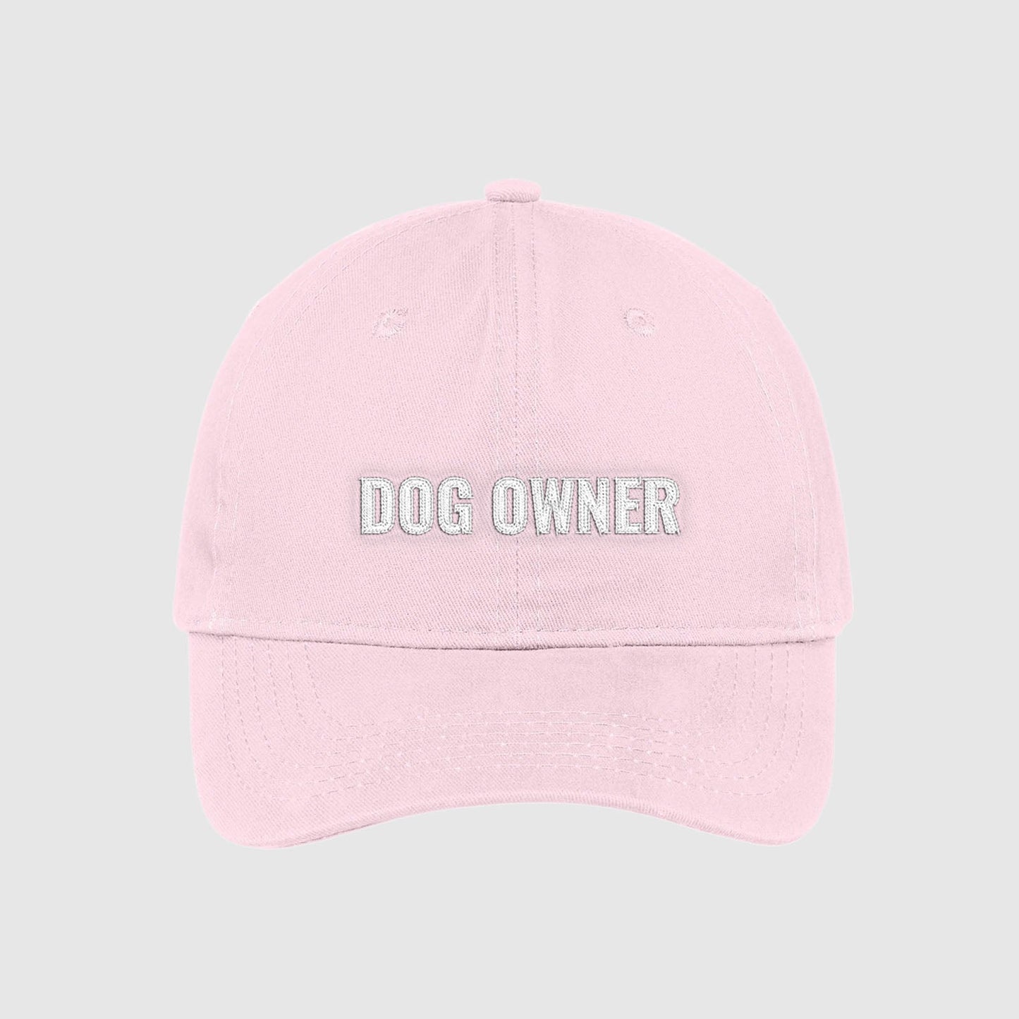 Blush light pink dad hat with Dog Owner embroidered on the front with white thread.