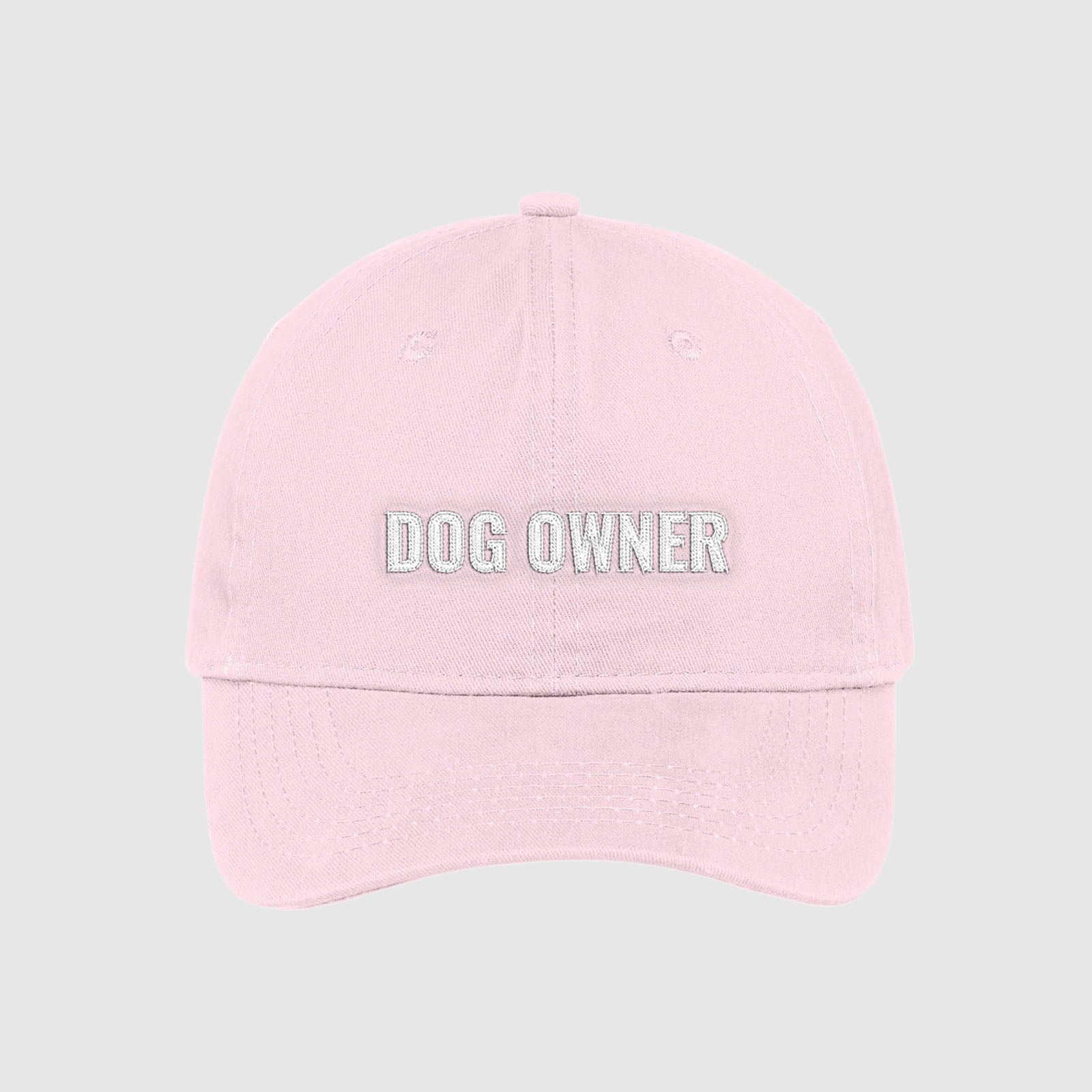 Blush light pink dad hat with Dog Owner embroidered on the front with white thread.