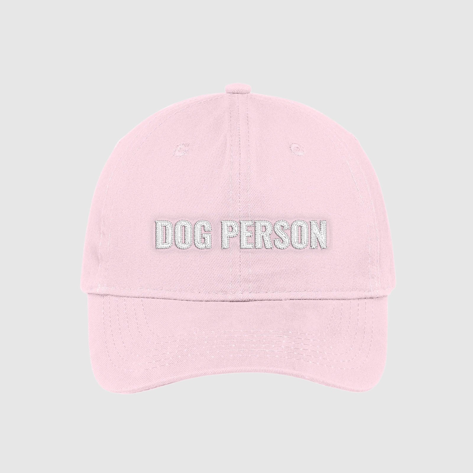 Blush light pink dad hat with Dog Person embroidered on the front with white thread.