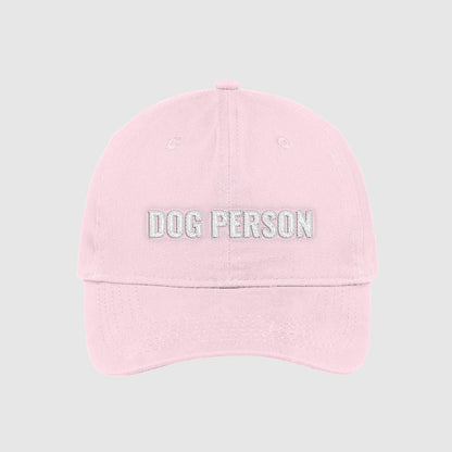 Blush light pink dad hat with Dog Person embroidered on the front with white thread.