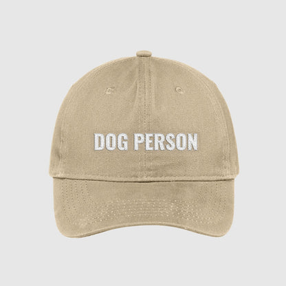 Khaki dad hat with Dog Person embroidered on the front with white thread.